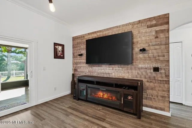 a bedroom with a bed and a tv