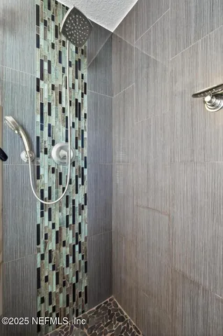 a living room with patio furniture and a floor to ceiling window