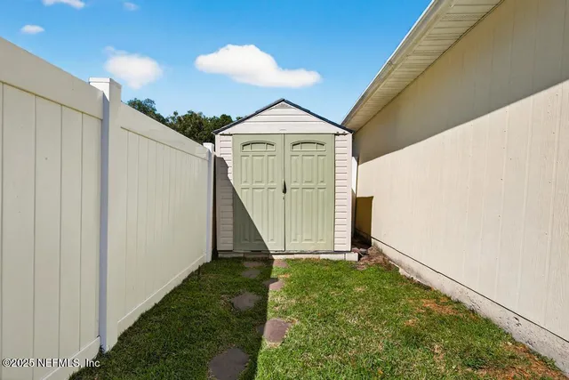 a outdoor view of a house with basket ball court tables and chairs
