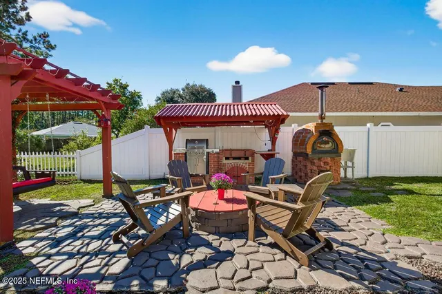 a view of a house with a yard and furniture