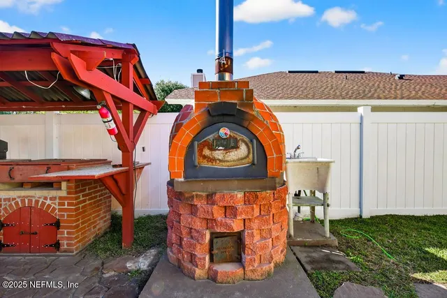 a view of a house with backyard and sitting area