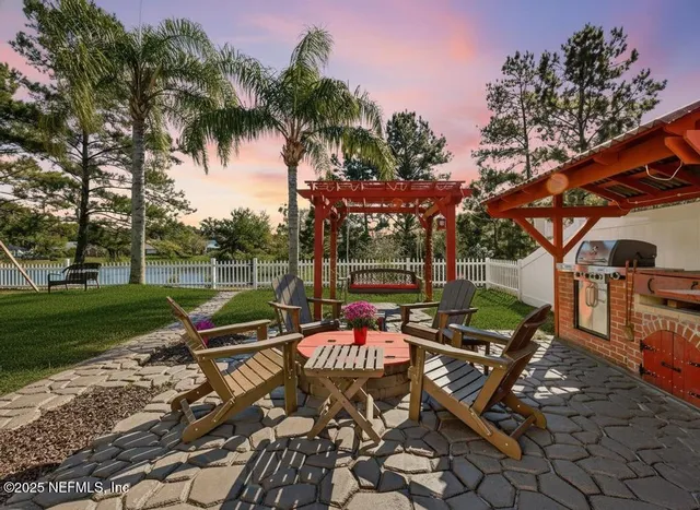 a view of a hallway with wooden floor kitchen and living room