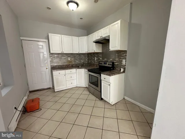 a kitchen with a sink and a stove top oven
