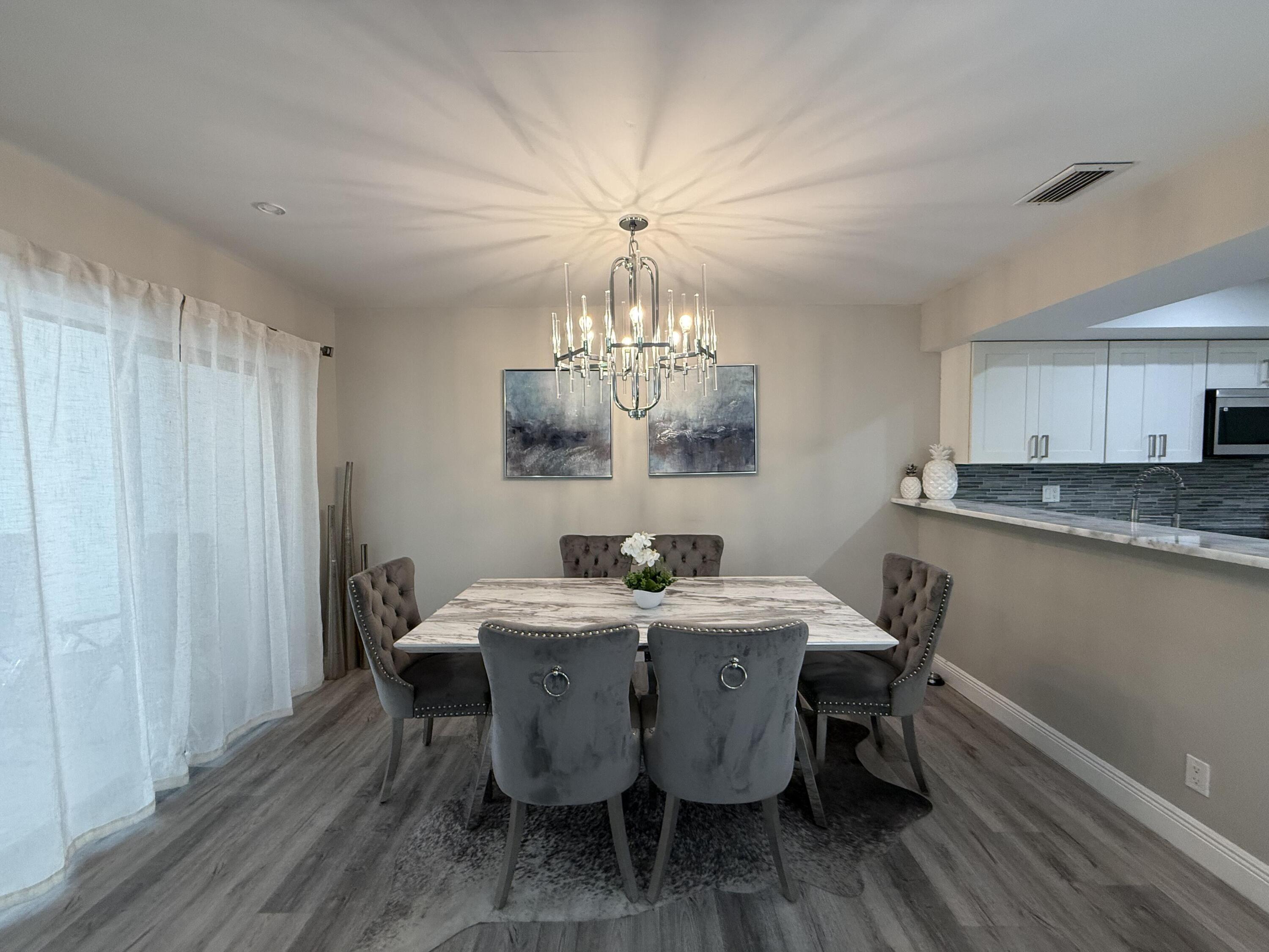22874 Ironwedge Drive Boca Raton, FL 33433 - Photo 13 of 52 a view of a dining room with furniture window and wooden floor