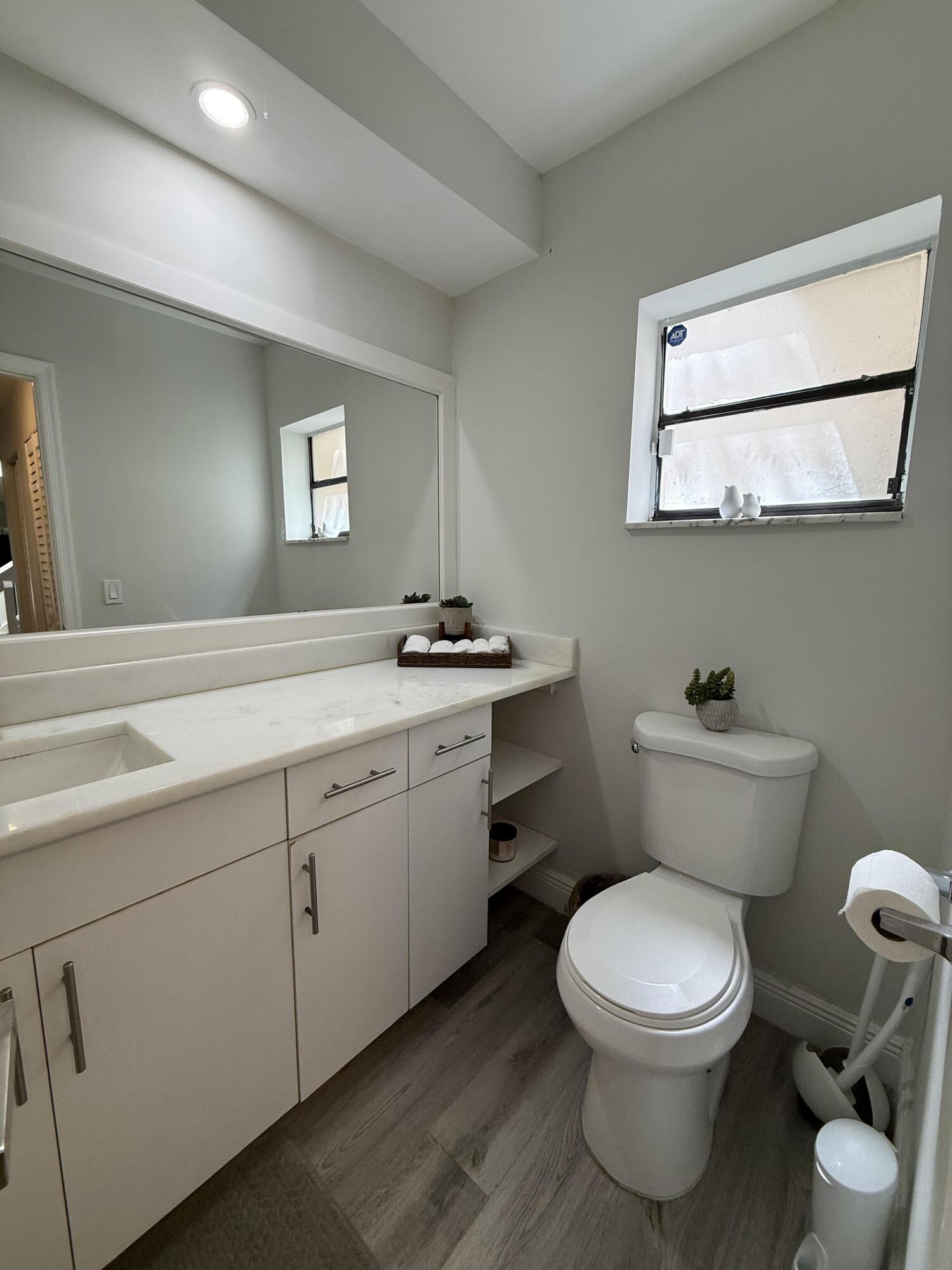 22874 Ironwedge Drive Boca Raton, FL 33433 - Photo 18 of 52 a bathroom with a toilet sink and mirror