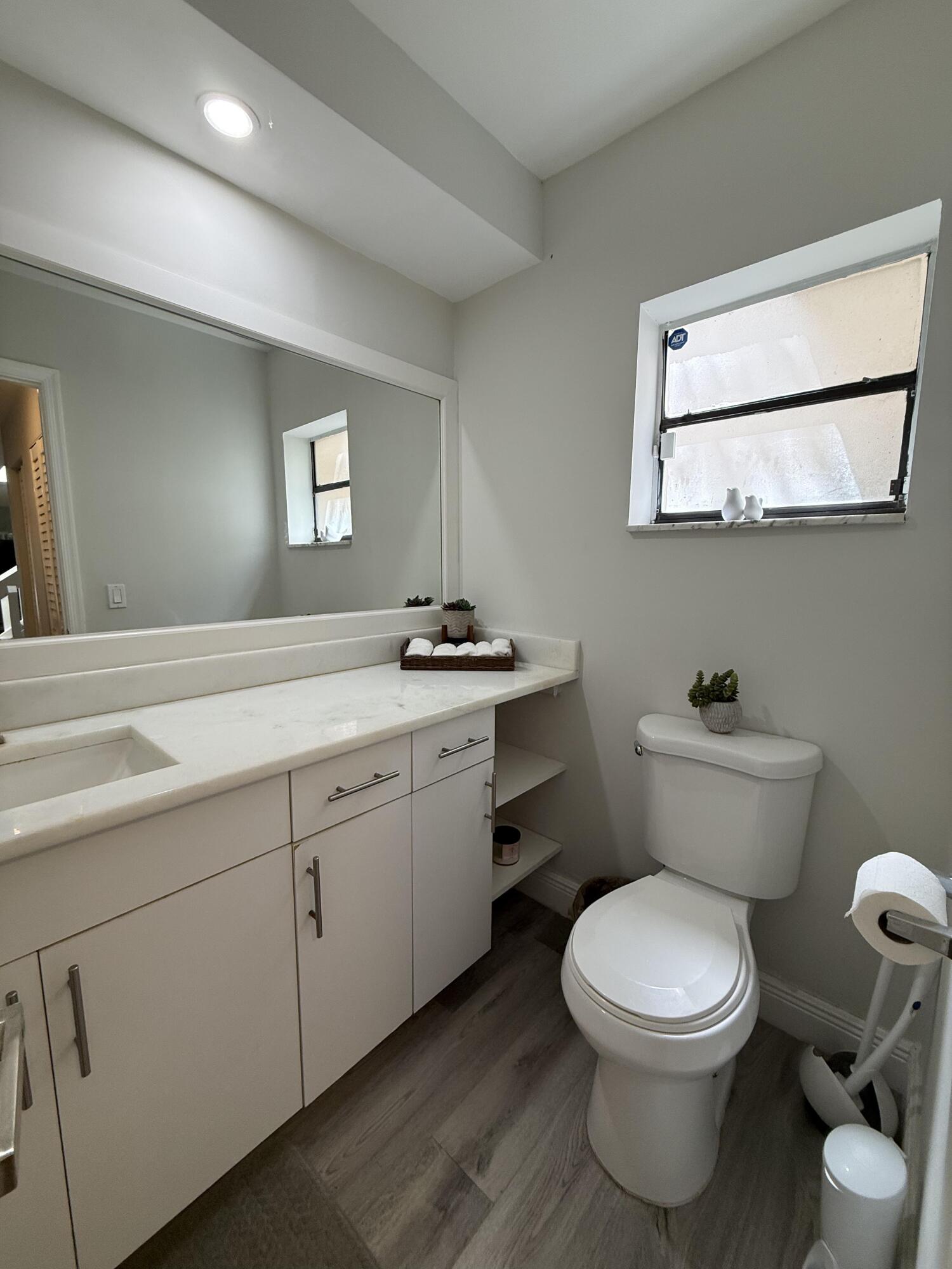 22874 Ironwedge Drive Boca Raton, FL 33433 - Photo 19 of 52 a bathroom with a toilet sink and mirror