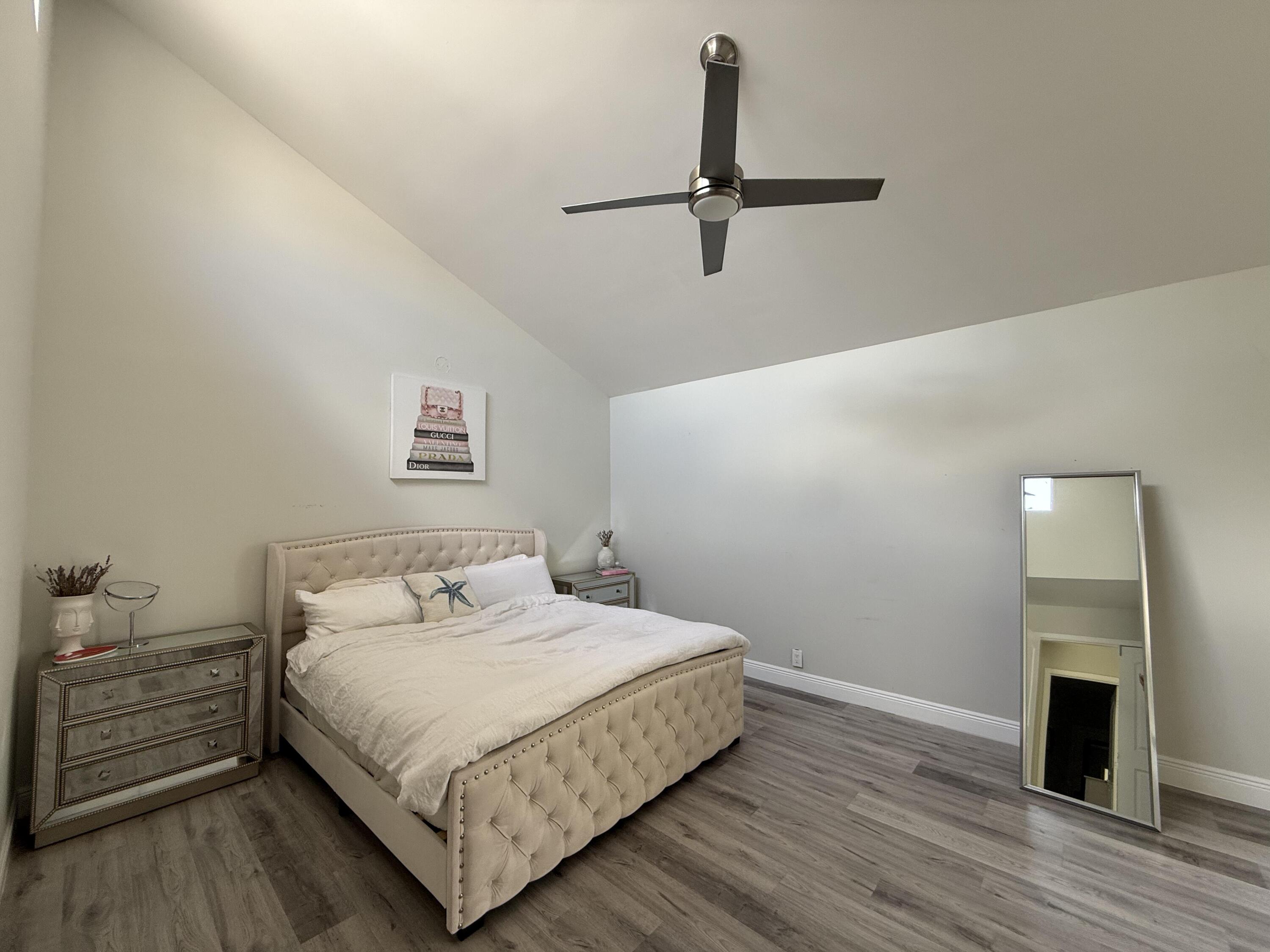 22874 Ironwedge Drive Boca Raton, FL 33433 - Photo 21 of 52 a bedroom with a bed and a fireplace