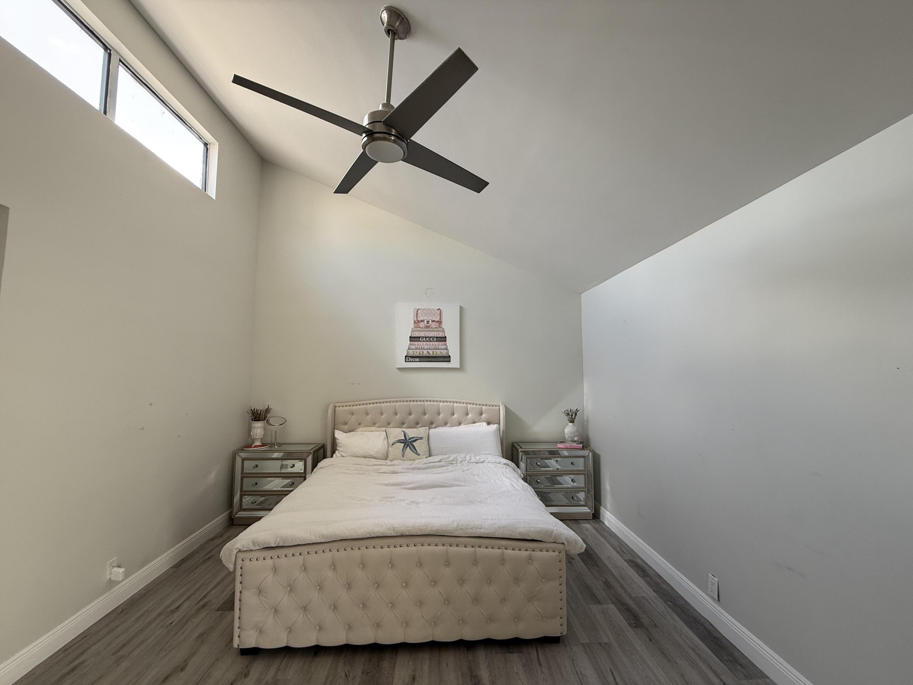 22874 Ironwedge Drive Boca Raton, FL 33433 - Photo 22 of 52 a bedroom with a bed and a window