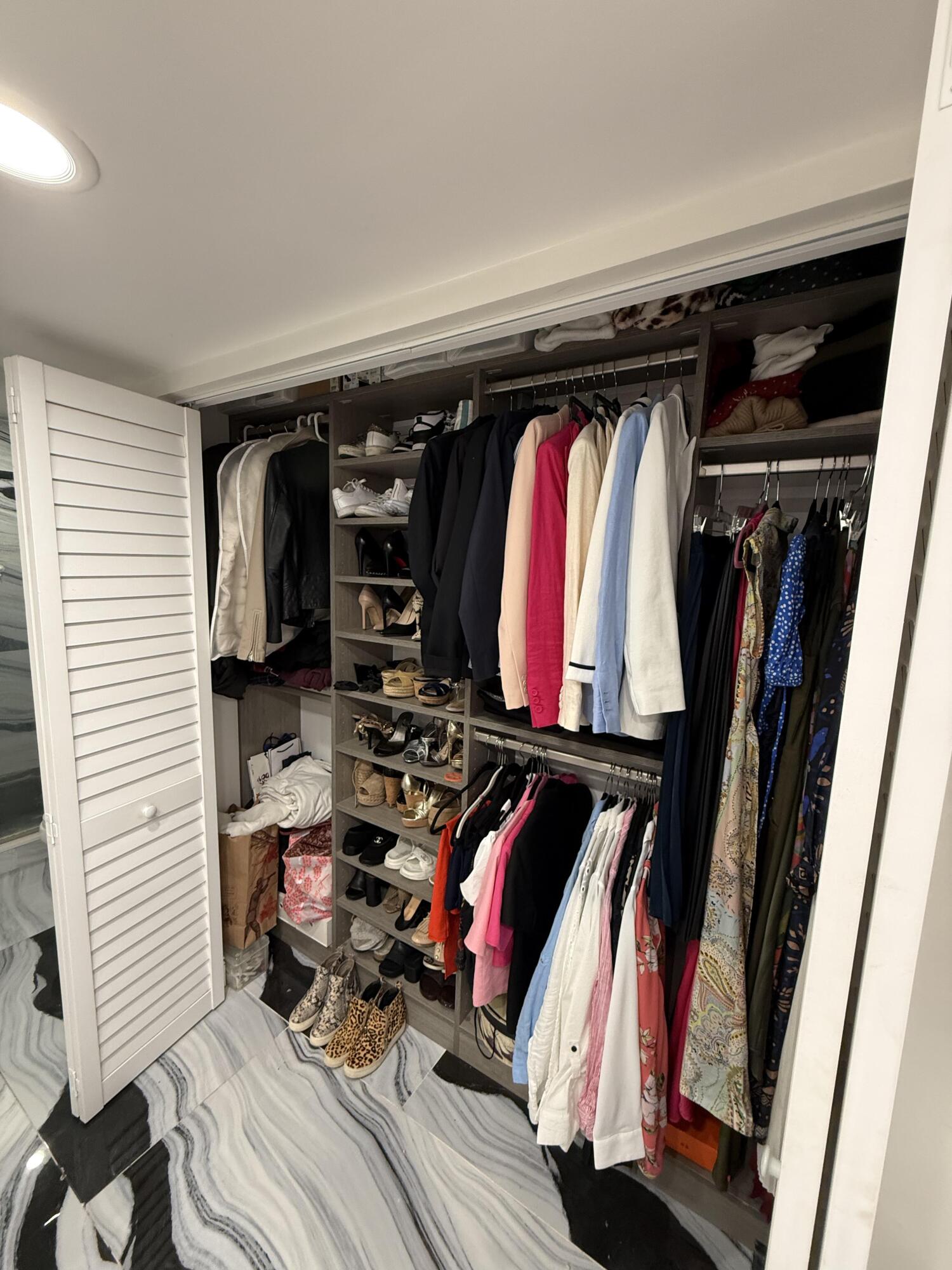22874 Ironwedge Drive Boca Raton, FL 33433 - Photo 31 of 52 a view of walk in closet with clothes and shoes
