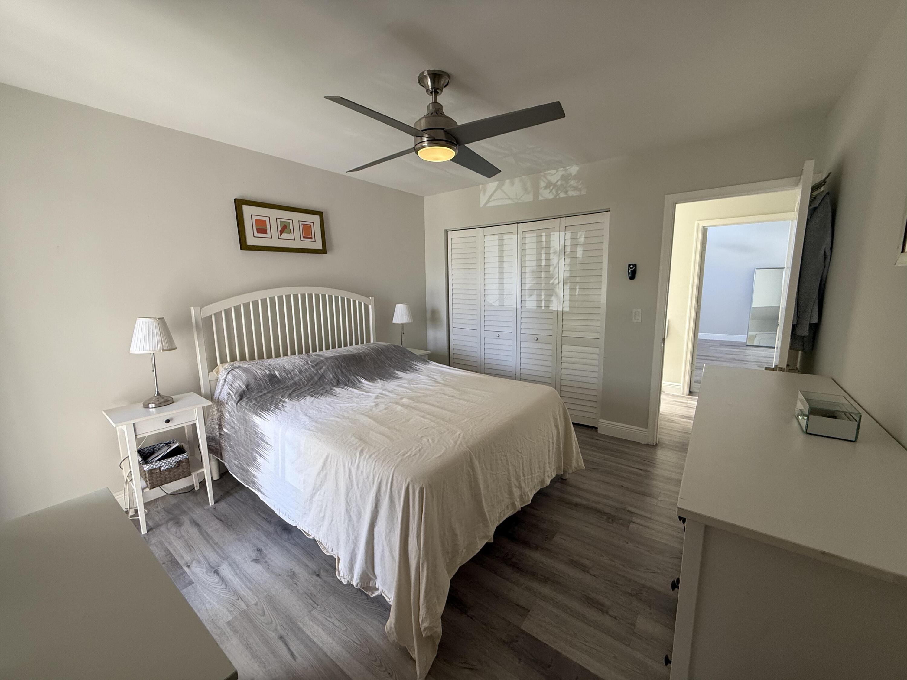 22874 Ironwedge Drive Boca Raton, FL 33433 - Photo 32 of 52 a bedroom with a bed and a chandelier