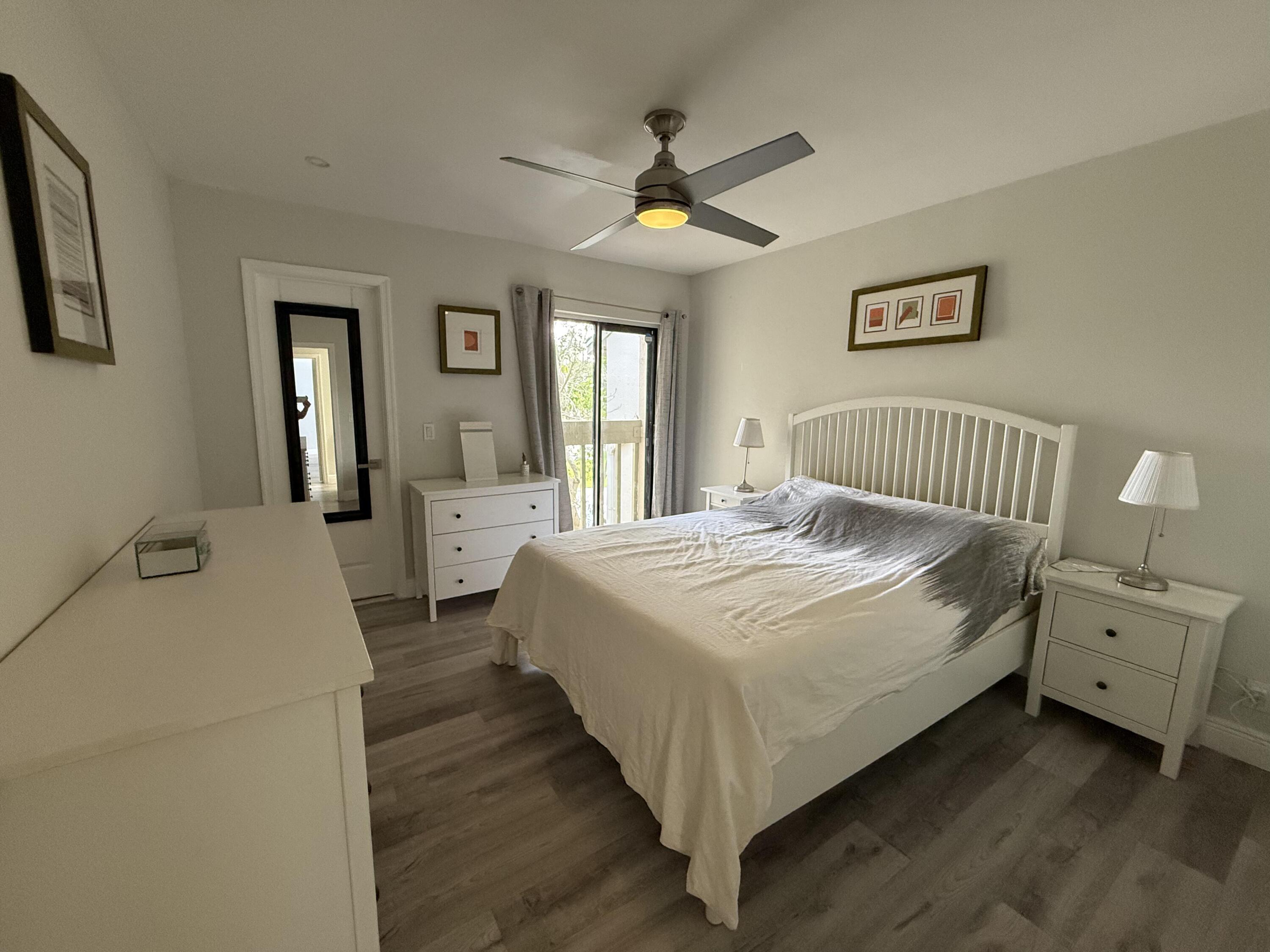 22874 Ironwedge Drive Boca Raton, FL 33433 - Photo 33 of 52 a spacious bedroom with a bed and a chandelier