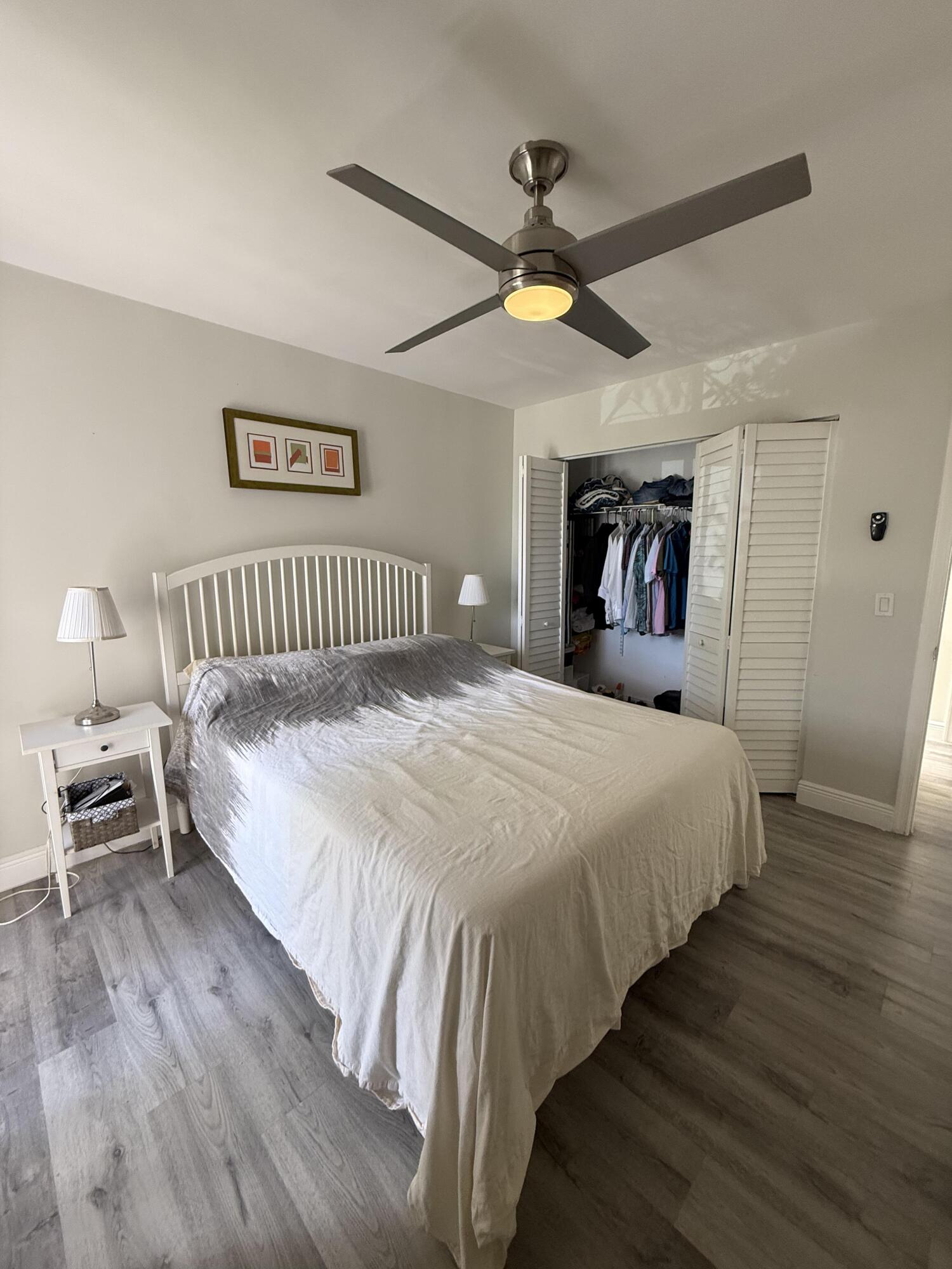 22874 Ironwedge Drive Boca Raton, FL 33433 - Photo 34 of 52 a bedroom with a bed and a chandelier