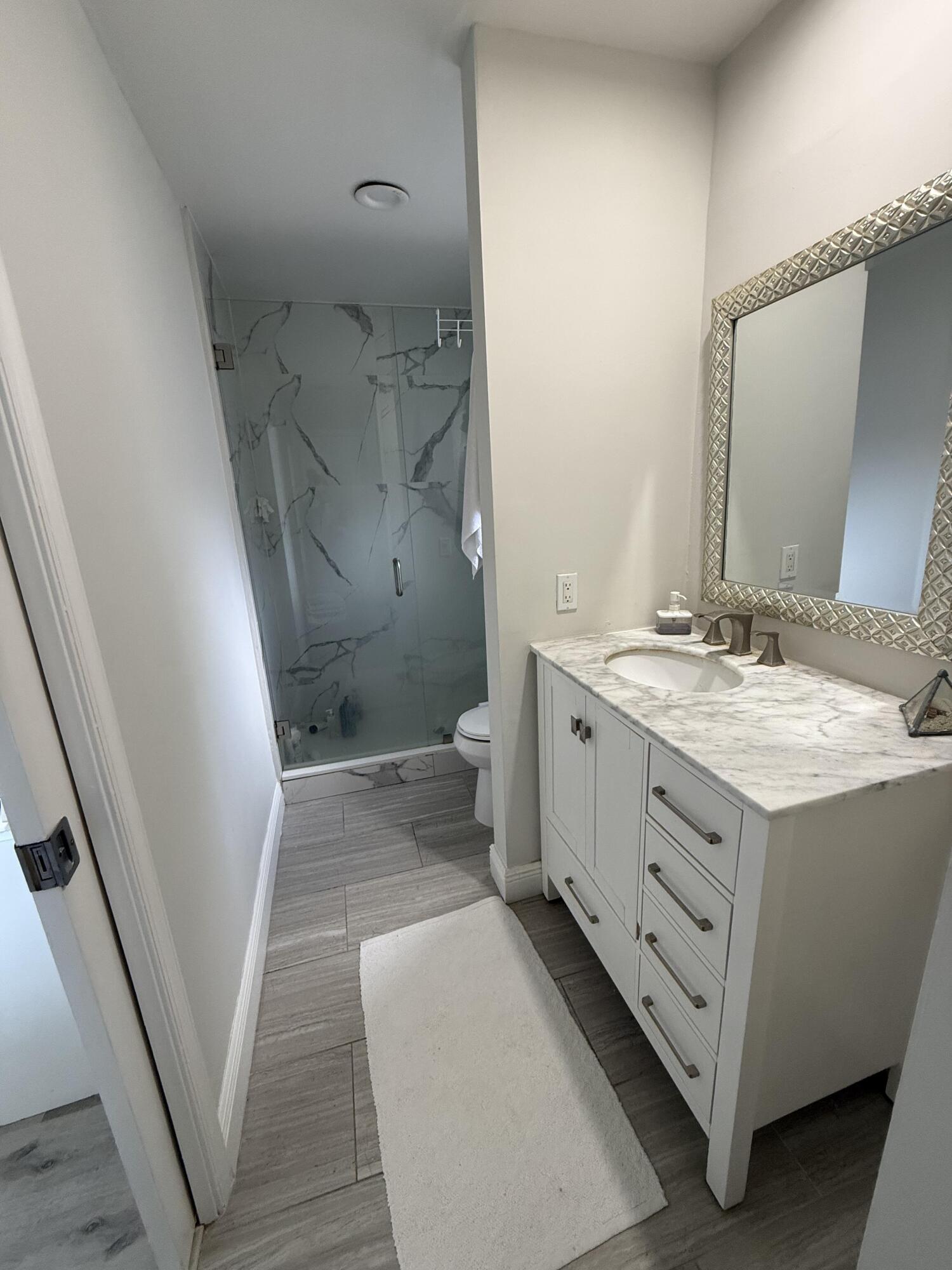 22874 Ironwedge Drive Boca Raton, FL 33433 - Photo 35 of 52 a bathroom with a double vanity sink and mirror with toilet