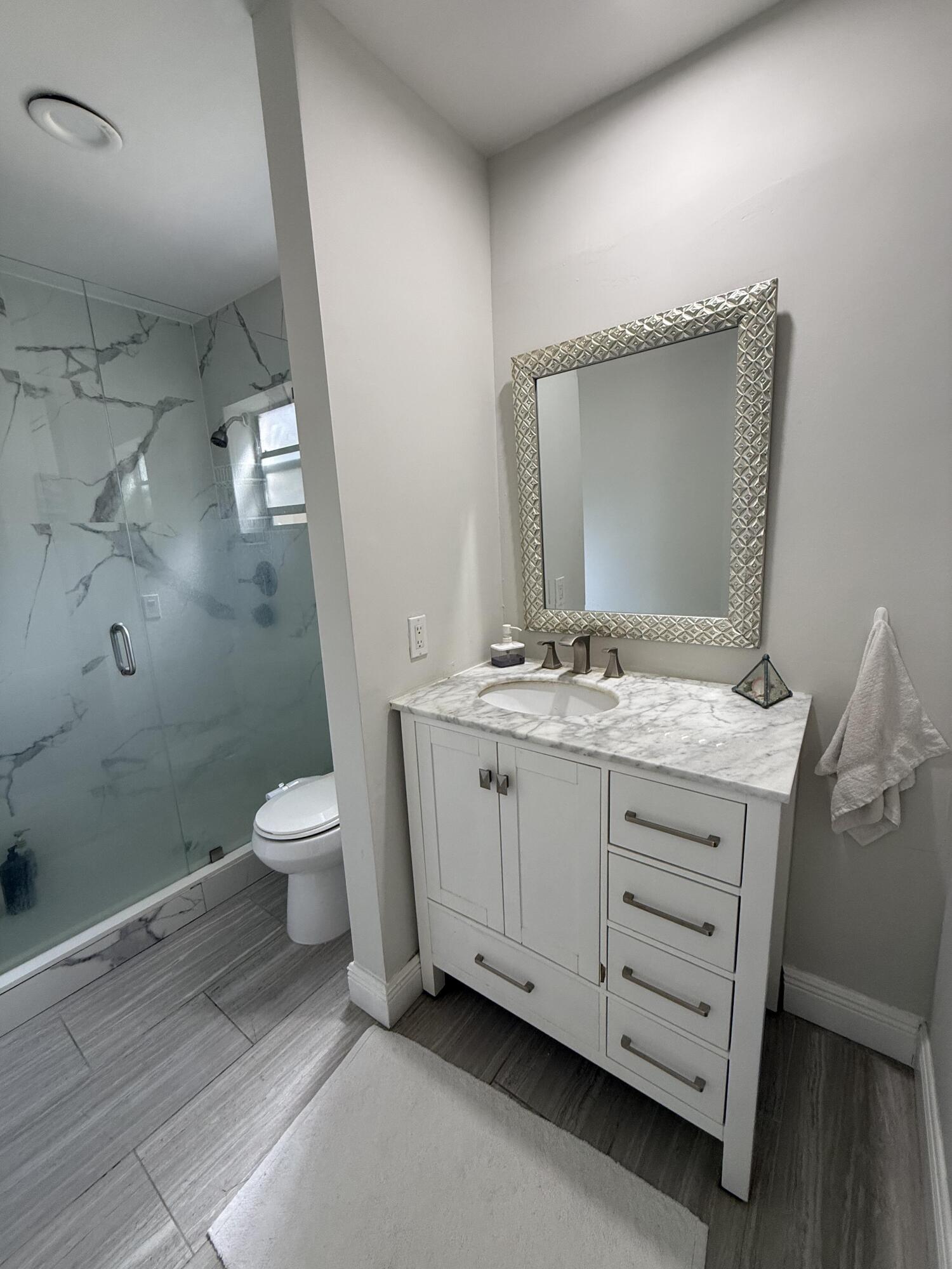 22874 Ironwedge Drive Boca Raton, FL 33433 - Photo 36 of 52 a bathroom with a granite countertop sink toilet and shower