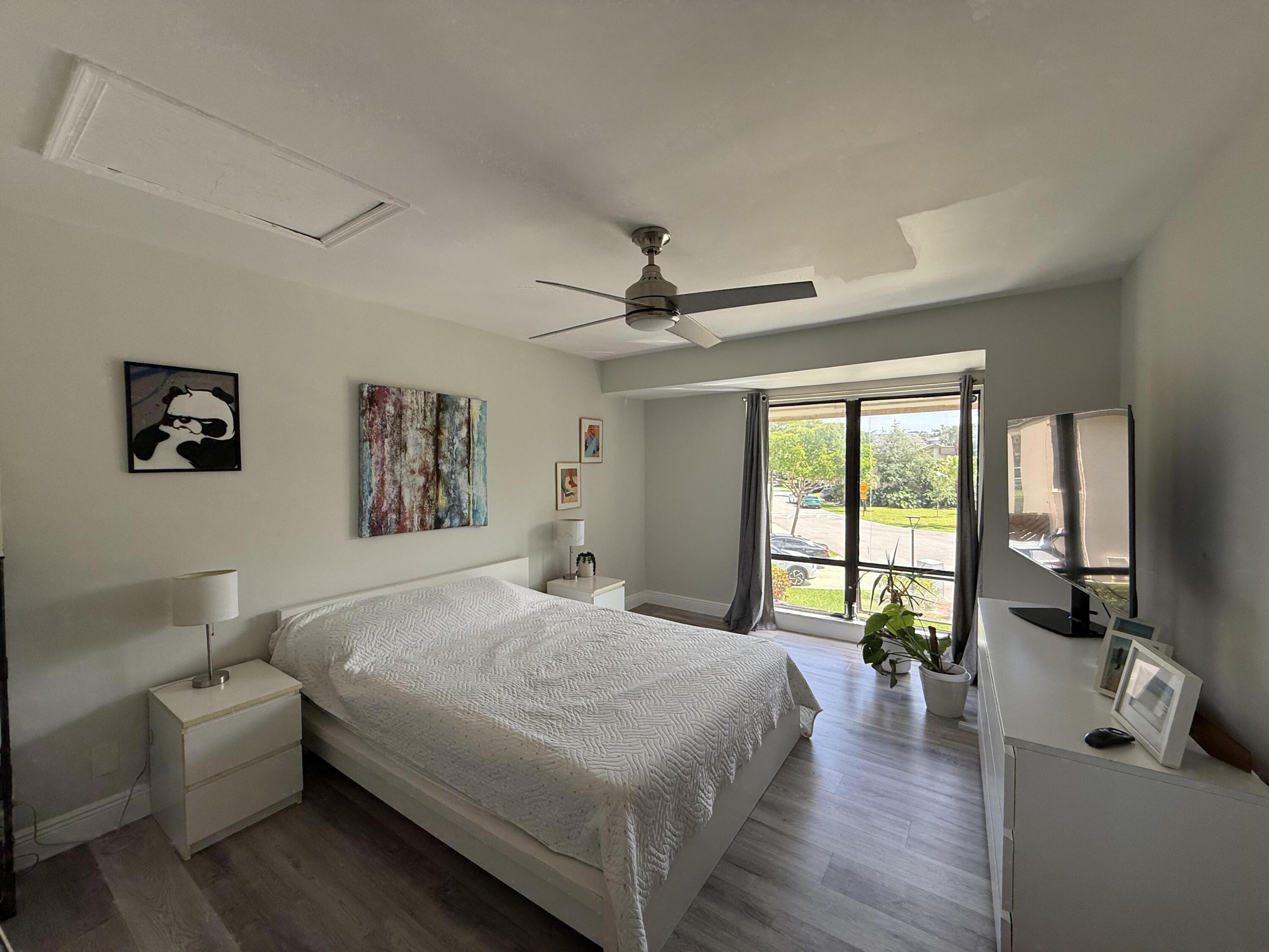 22874 Ironwedge Drive Boca Raton, FL 33433 - Photo 37 of 52 a bedroom with a bed furniture and a large window