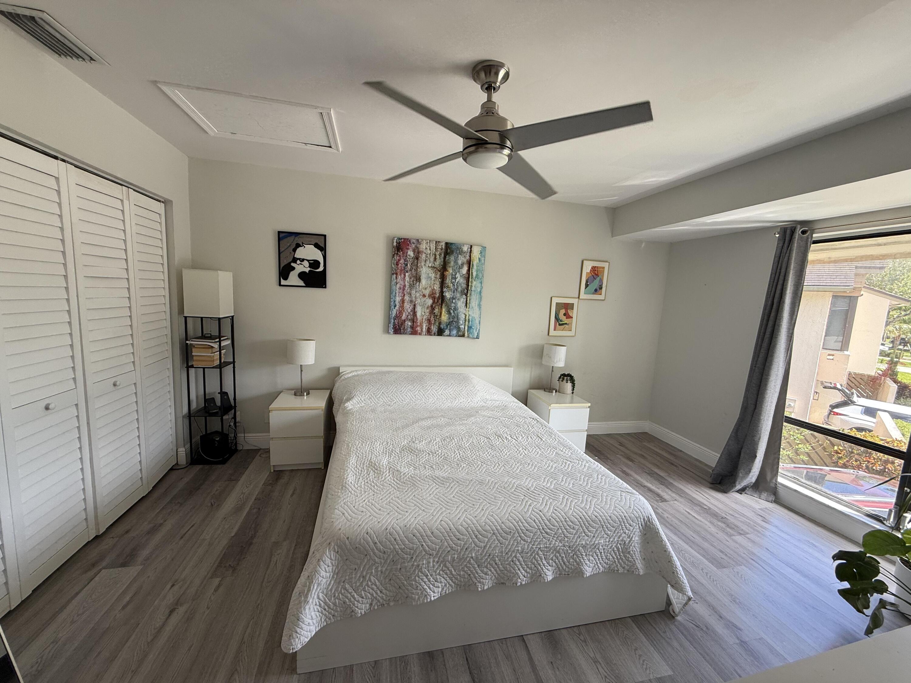 22874 Ironwedge Drive Boca Raton, FL 33433 - Photo 39 of 52 a bedroom with a bed and a large mirror