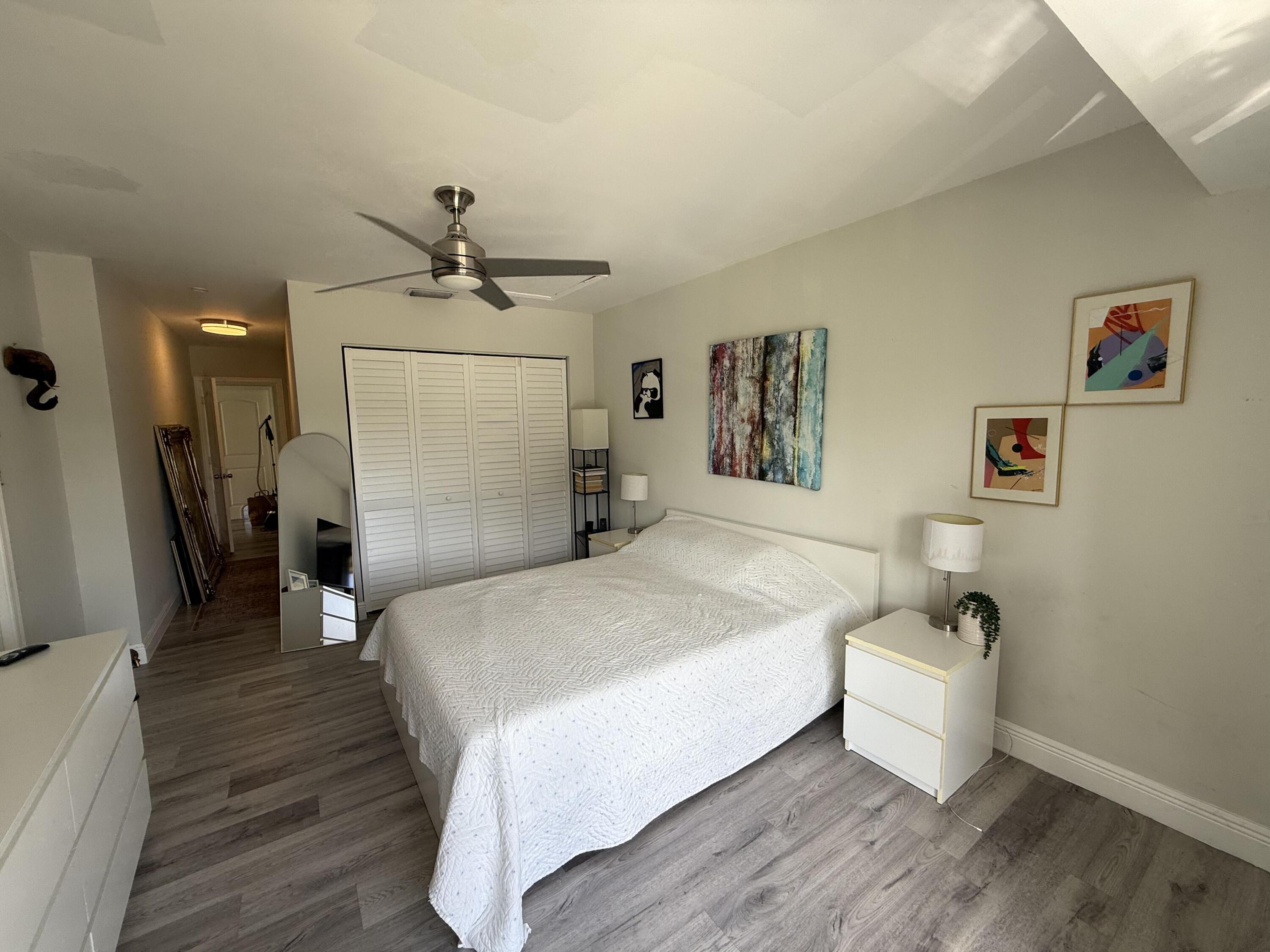 22874 Ironwedge Drive Boca Raton, FL 33433 - Photo 40 of 52 a bed room with a bed and a chandelier