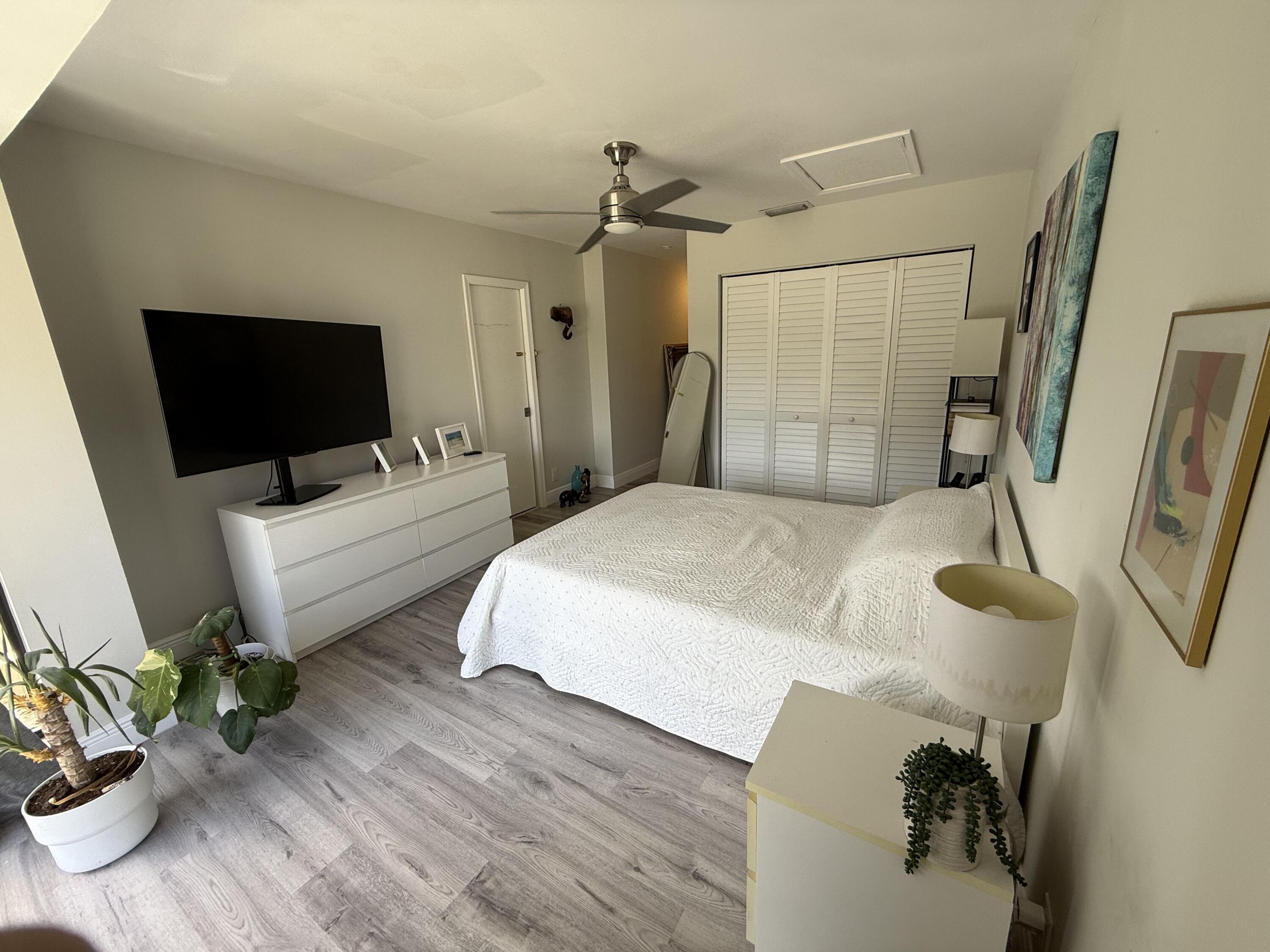 22874 Ironwedge Drive Boca Raton, FL 33433 - Photo 41 of 52 a bedroom with a bed and wooden floor