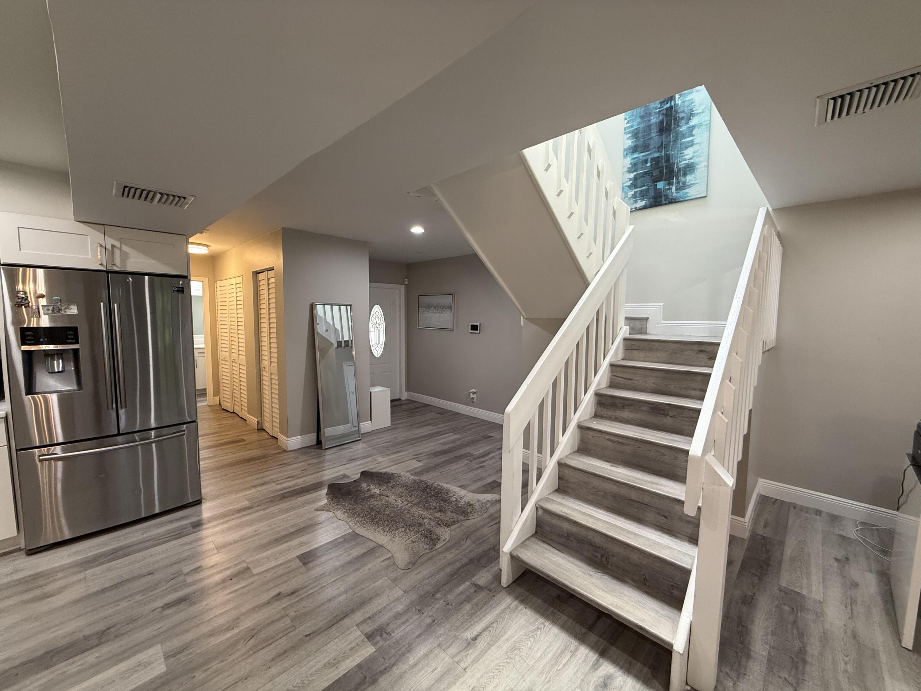 22874 Ironwedge Drive Boca Raton, FL 33433 - Photo 8 of 52 a view of entryway and hall with wooden floor