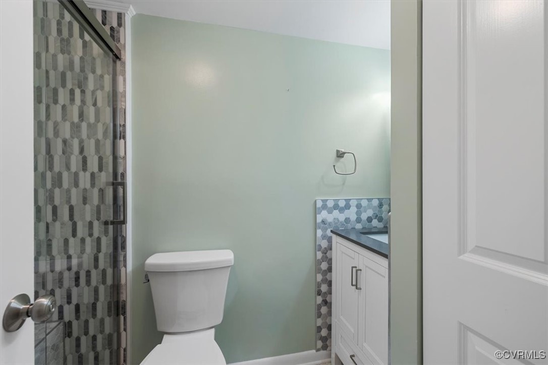 1501 Thistle Road, Unit 203 Richmond, VA 23238 - Photo 18 of 30 a bathroom with a toilet and a shower curtain