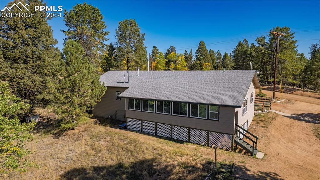 455 Golden Bell Lane Divide, CO 80814 - Photo 30 of 30 a view of a roof deck with wooden fence and a floor to ceiling window