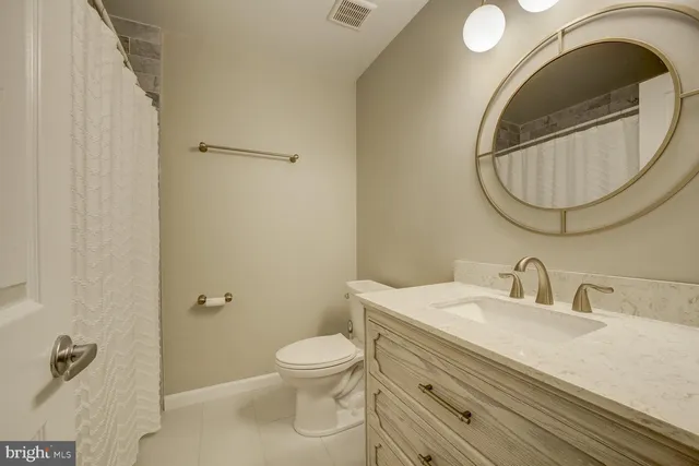 a bathroom with a sink mirror and toilet