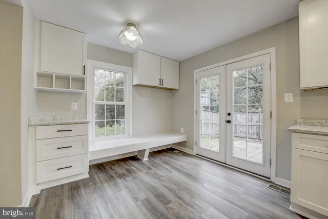 a view of wooden floor and windows in a room