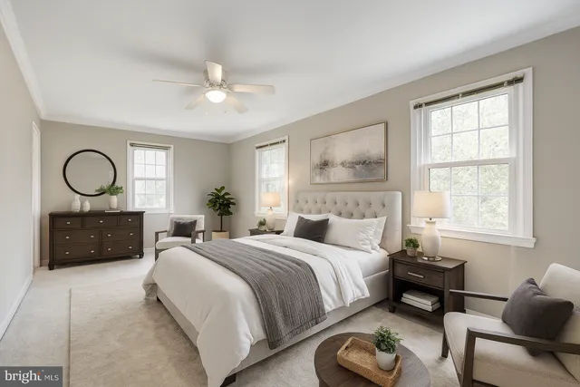 a bedroom with a bed couches and a dresser