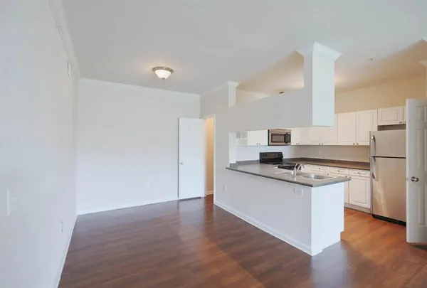 a kitchen with a refrigerator sink and white cabinets