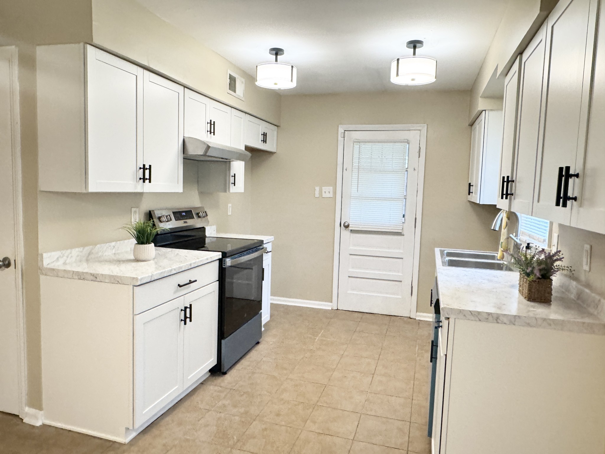 3824 Cazassa Road Memphis, TN 38116 - Photo 6 of 25 a kitchen with a sink stove and refrigerator