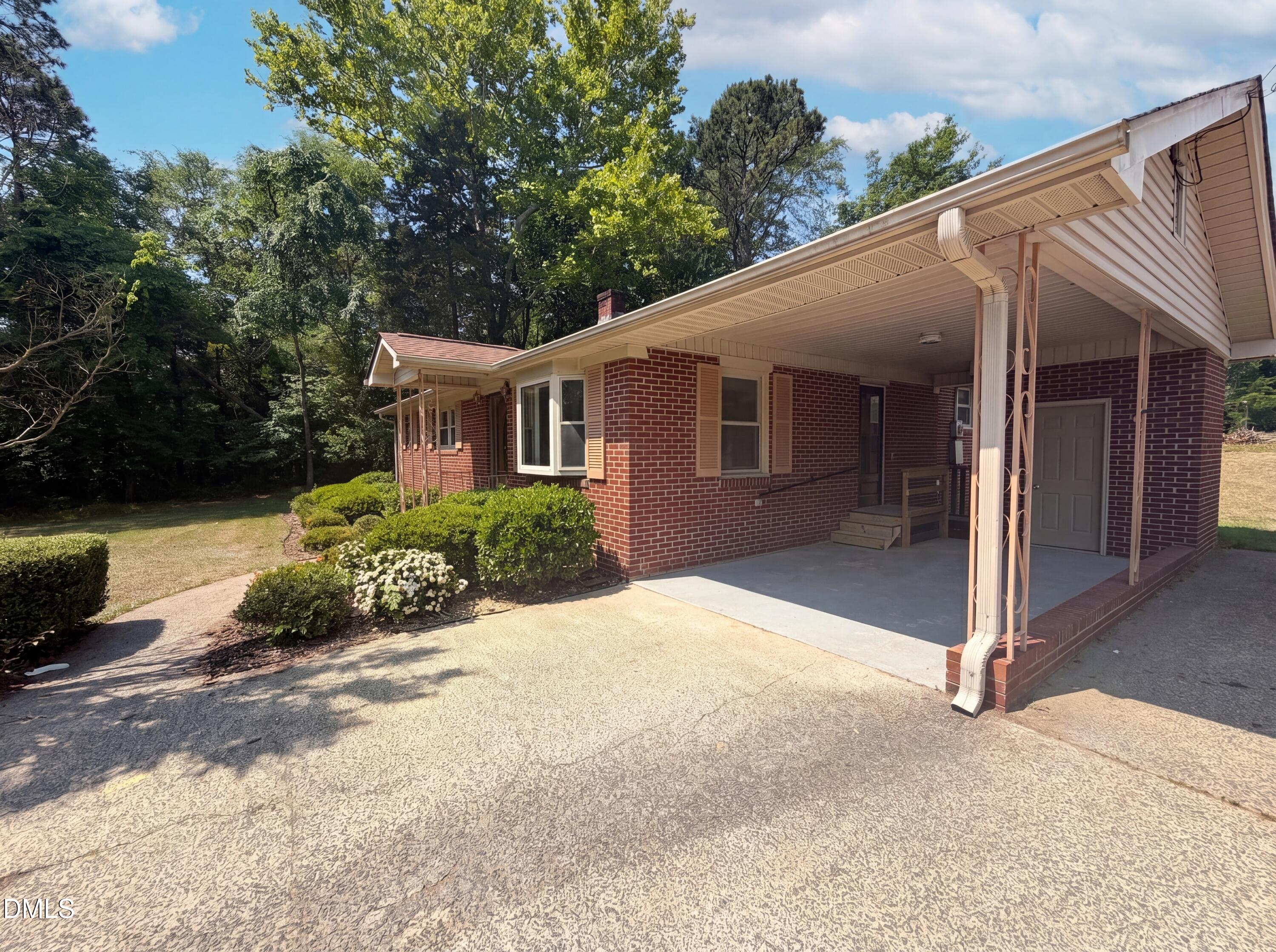 1710 West B Street Butner, NC 27509 - Photo 14 of 14 a front view of a house with a yard and potted plants