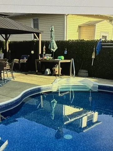 a view of a swimming pool with a patio