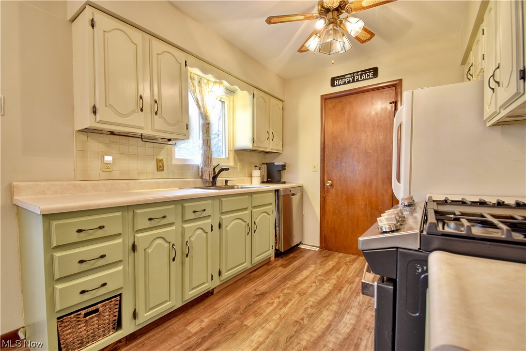 8044 Bellflower Road Mentor, OH 44060 - Photo 6 of 33 Kitchen with sink, light wood-type flooring, ceiling fan, dishwasher, and tasteful backsplash