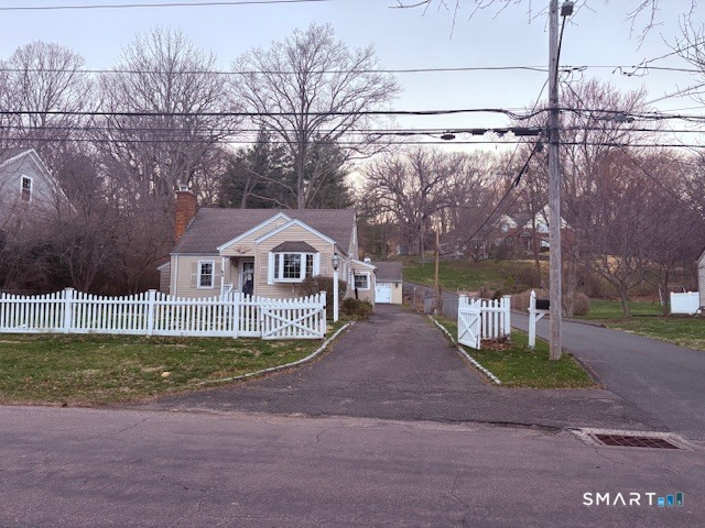 329 Bronson Road Fairfield, CT 06890 - Photo 1 of 25 a front view of a house with a yard and garage