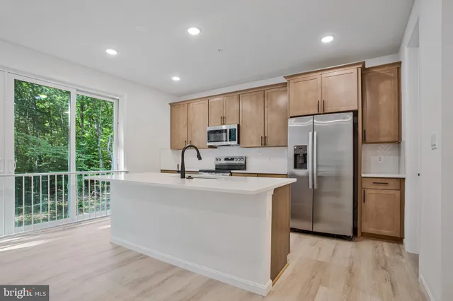 a kitchen with refrigerator cabinets and a sink