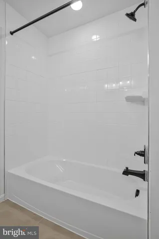 a bathroom with a shower and a bath tub