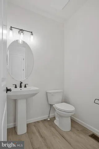 a bathroom with a sink toilet and mirror