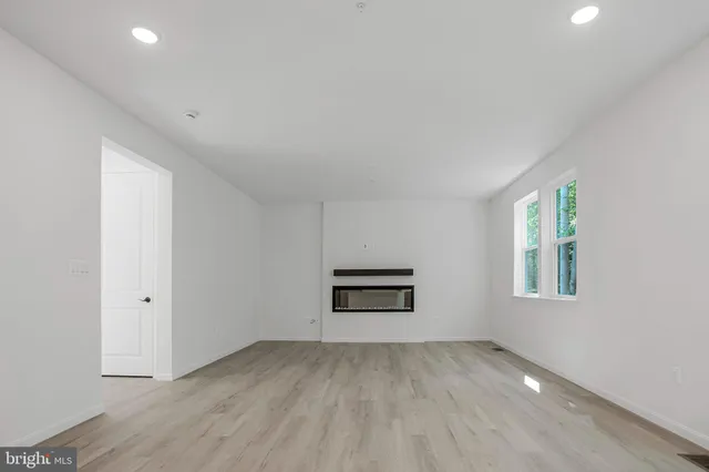 an empty room with a window and cabinet
