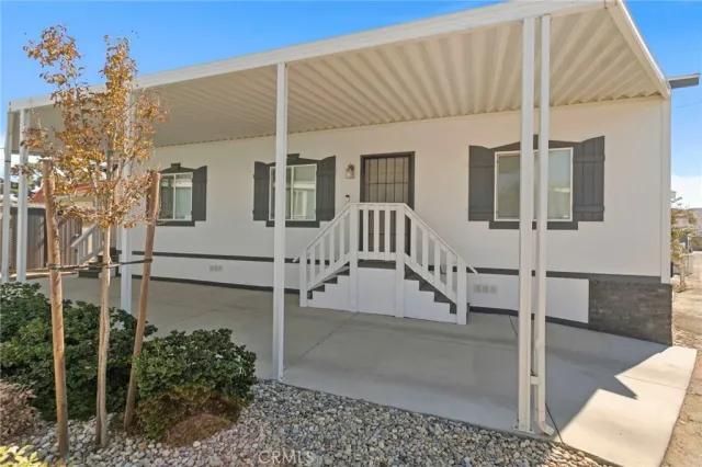a large white kitchen with stainless steel appliances granite countertop a stove a sink and a refrigerator