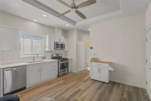 a kitchen with stainless steel appliances granite countertop a stove and a microwave