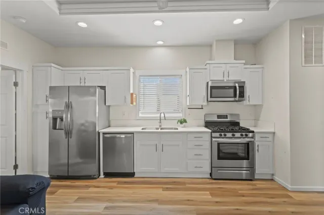 a view of a room with a ceiling fan and wooden floor