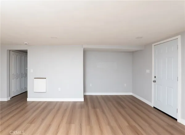 a view of an empty room and wooden floor