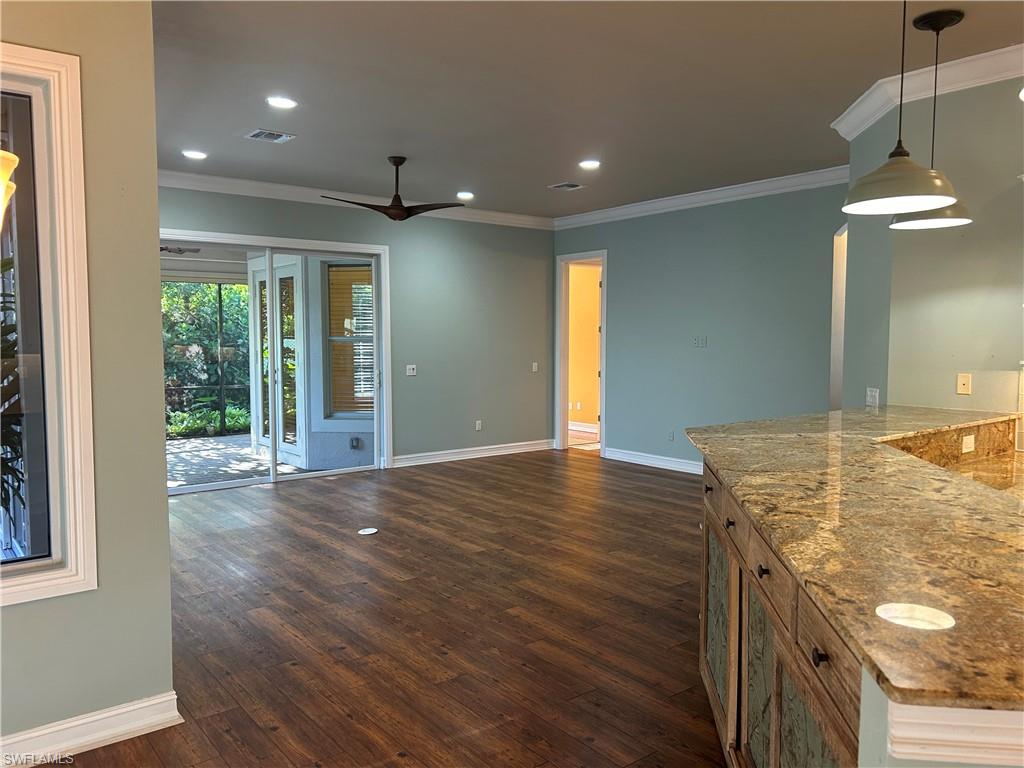 4956 Rustic Oaks Circle Naples, FL 34105 - Photo 1 of 10 a view of an empty room with window and wooden floor