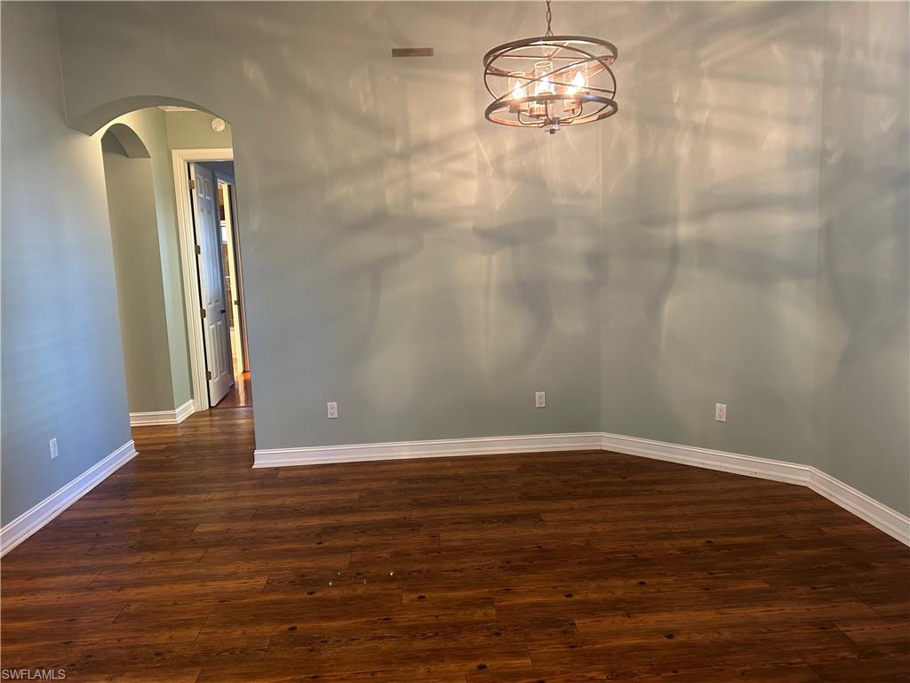 4956 Rustic Oaks Circle Naples, FL 34105 - Photo 2 of 10 a view of empty room with wooden floor and fan