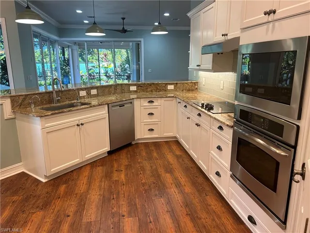 a kitchen with granite countertop a stove and a sink