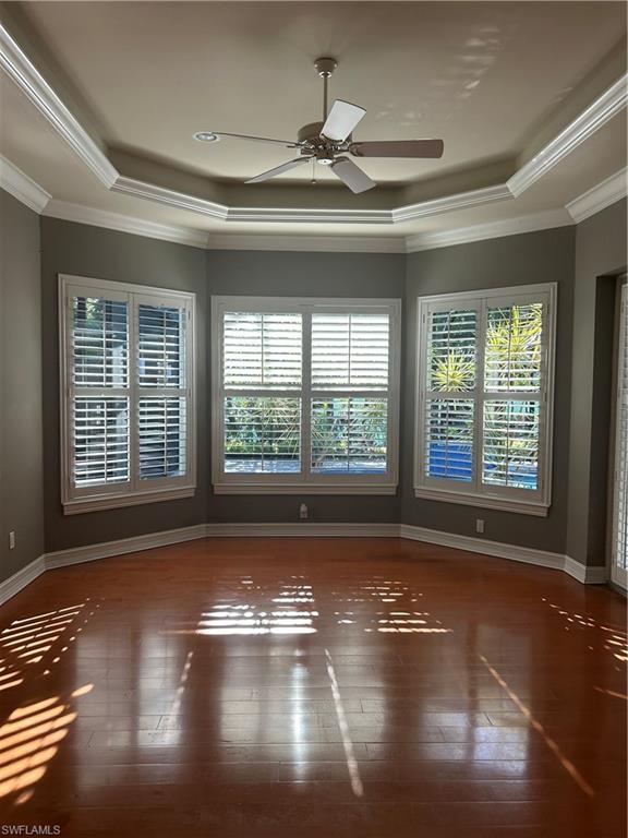 4956 Rustic Oaks Circle Naples, FL 34105 - Photo 7 of 10 a view of empty room with wooden floor and fan