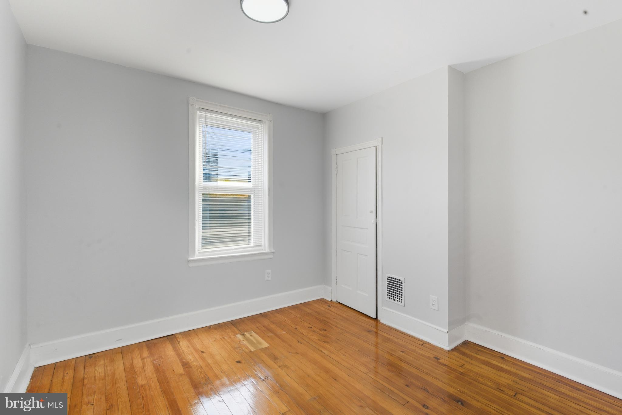 5632 Addison Street Philadelphia, PA 19143 - Photo 11 of 14 a view of an empty room with wooden floor and a window