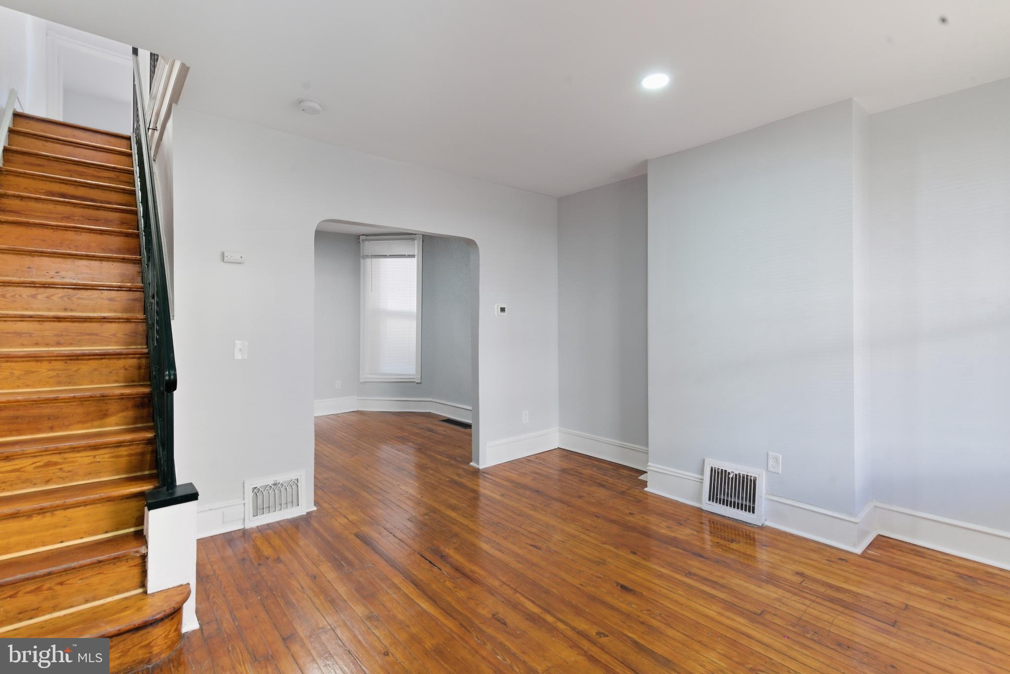 5632 Addison Street Philadelphia, PA 19143 - Photo 4 of 14 a bedroom with a bed and wooden floor