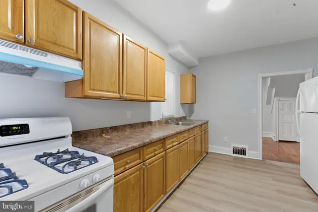 a kitchen with stainless steel appliances granite countertop a sink stove and cabinets