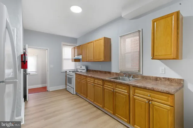 a kitchen with stainless steel appliances granite countertop a sink and cabinets